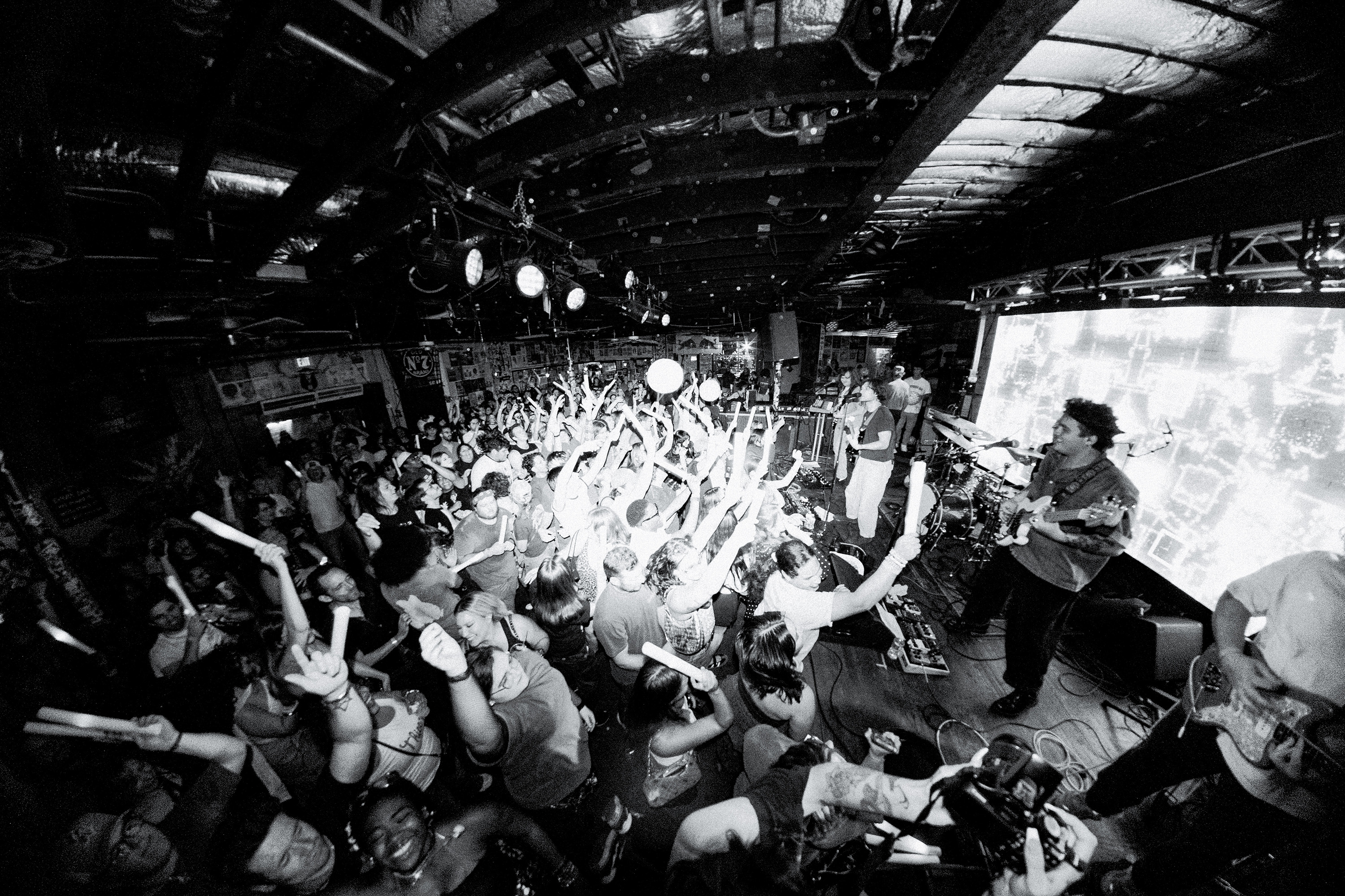 Side stage shot of the band performing.