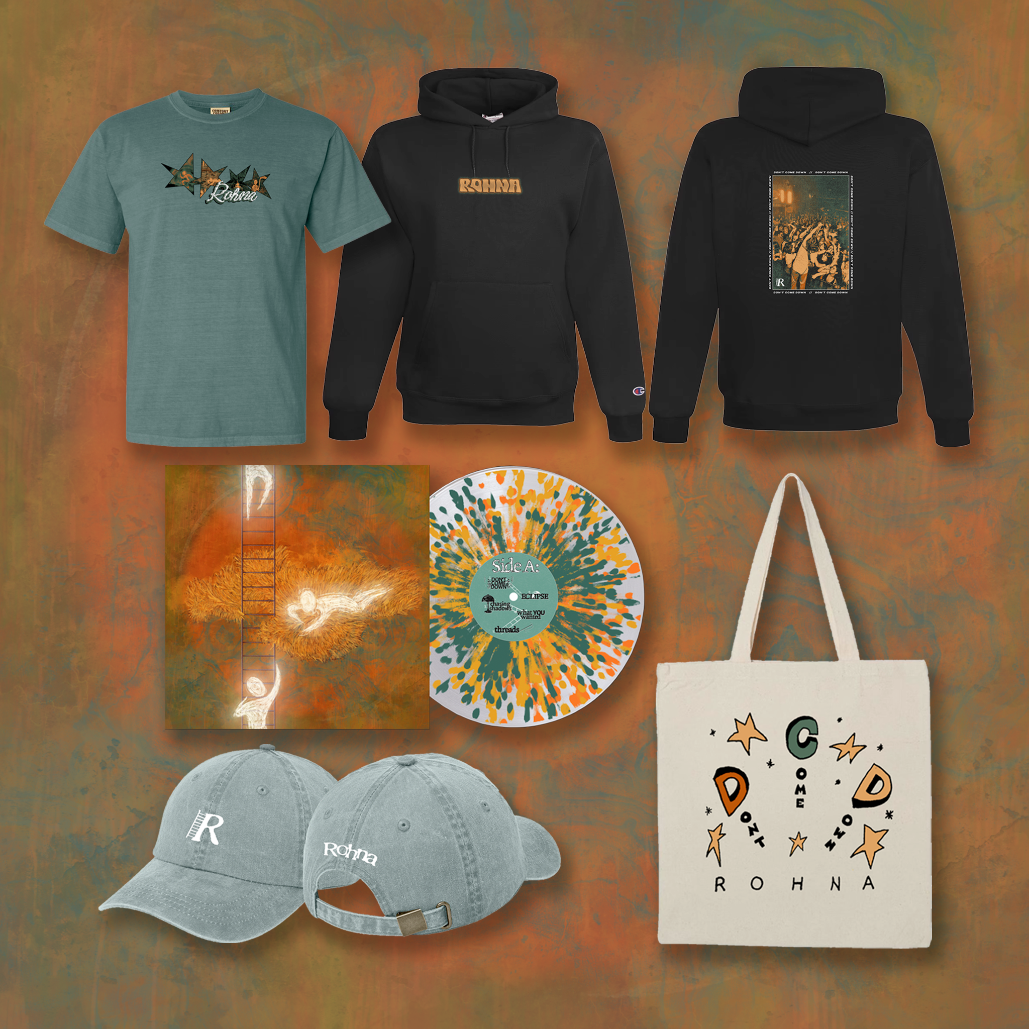 A display of band merchandise including a vinyl record, shirt, tote bag, hat, and hoodie.